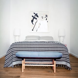 In keeping with Hayon’s goal of creating a serene and airy home, the master bedroom sticks to a mostly neutral palette of whites and grays. The bench by the bed is a custom piece designed by Hayon and Klunder and fabricated by their carpenter friend Josep Joffre.