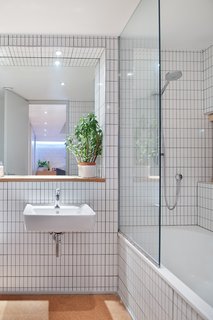"I put everything that I've always loved into this house," says Tyler—and that includes white tiles edged with gray grout in the bathroom, a design move previous clients had balked at.