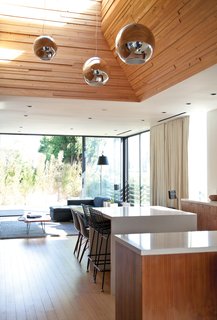 You Won't Be Calling This House a "Man Cave" - Photo 8 of 9 - The Globo di Luce pendants in the kitchen are by Roberto Menghi for Fontana Arte.