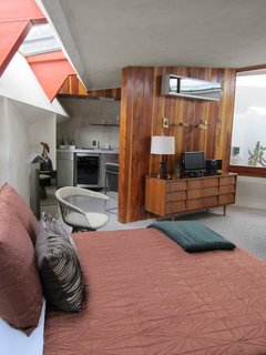 The Midcentury Architecture of California Modernist John Lautner - Photo 5 of 6 - Today the boutique hotel is outfitted with swanky midcentury furnishings, including a Milo Baughman sofa, a polished chrome coffee table by J. Wade Beam, a pair of Bertoia barstools, and a Thonet-inspired chair.