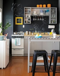 10 Stunning Ways to Use Black in Your Kitchen - Photo 2 of 10 - This kitchen manages to look playful and edgy with chalkboard paint: the matte black is crisp, but the scribbles add whimsy. Reprinted from The First Apartment Book by Kyle Schuneman. Copyright © 2012. Published by Clarkson Potter, a division of Random House, Inc.