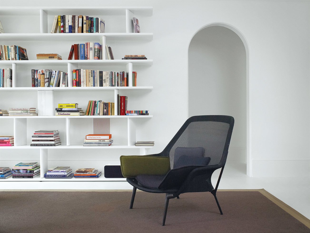 Vitra?s Slow chair sits in front of a powder-coated-steel bookcase made by Hill?s go-to fabricator, George Sacaris; it was originally built for the Houston house.