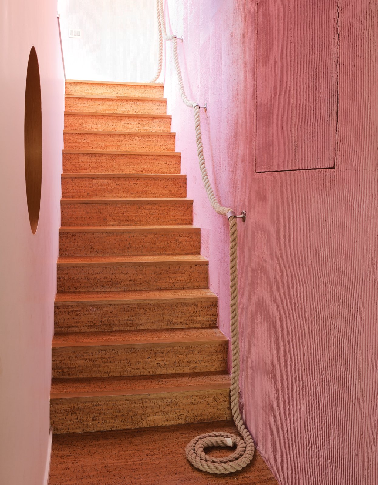 The cork stairs with a rope railing lead down to the kids’ level.