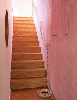 The cork stairs with a rope railing lead down to the kids’ level.