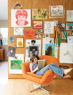 The pair’s art covers a cork wall where Eva Luna reads in a vintage Danish lounge chair.