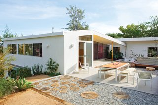 Some 35 percent of the materials from the renovation were resurrected in the yard: Redwood panels became fencing. Blocks cut from original concrete patios form the snake wall. And Purdy plans to crochet colorful cozies over various branches and stumps.