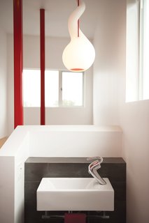 The Alien pendant light with red cord is by Constantin Wortmann for Next Design.