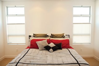 Traffic Gem<br><br>To mitigate the noisy bustle of South La Brea Avenue, Cooper designed the interior of her house so that less-used spaces would face the street. "I located the bathrooms, a bank of cabinets, and the closet between the street and the bedrooms," she reports, creating an aural buffer zone that helps her sleep at night. <br><br>Up from the Bottom<br><br>For the large windows in the living room and bedrooms, Cooper chose bottom-up roller shades to allow for both plenty of privacy and cascades of natural light. The translucent fabric of the Window Vogue shades means that even when the shades are rolled up to head height, a bit of California sun still shines through.<br><br>santamonicashadeandscreen.com