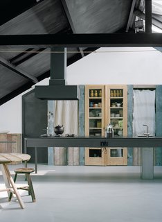 "We like old stuff, and we like reusing the same materials over and over again," says Middendorp, who built the kitchen pantry from the home’s old wooden flooring and zinc from their former countertop. Leen commissioned a local ironsmith to create the 11-foot-long kitchen island, as well as the staircase that connects her ground-floor workshop with the family’s living space upstairs.