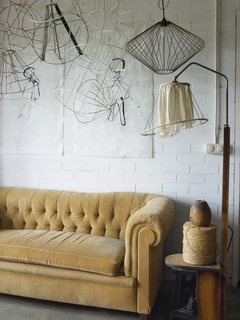 Here, with the help of an antique sofa and a woodburning stove, she "drinks coffee, gets inspired, and gets warm."