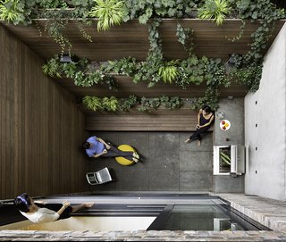 The dramatic 90-square-foot patio features a cooking and seating area. The floor and countertop are clad in Inca Gray Honed slate from Stone Source and the bench and planters are teak. By creating a vertical garden, Lubrano and Ciavarra integrated greenery into the views from every level of the house.