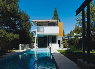 This House Doesn't Hold Back on Colorful Details - Photo 2 of 11 - Architects Tom Chastain, Renee Chow, and Antje Steinmuller of Studio Urbis installed Swisspearl siding as a rainscreen and used concrete flooring and walls to insulate the home and regulate its internal climate.
