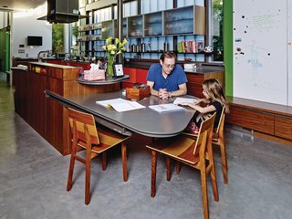 This House Doesn't Hold Back on Colorful Details - Photo 5 of 11 - In the kitchen, the walls near the garden are painted green. The built-in table was designed by Chastain, and the Tone chairs are from De La Espada.