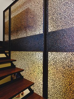 This House Doesn't Hold Back on Colorful Details - Photo 10 of 11 - Shadow Play 3form Varia Ecoresin Organics panels were used as sidewalls for the stairwell. The material is a translucent resin that permits light to pass, making the adjacent spaces seem bigger. Silhouetted figures going up and down the stairs animate the room. Effects can be varied and modulated with panels of different textures from different suppliers, such as 3form, Panelite, and Bendheim. Panels can also be mounted in simple aluminum U-channels to be used as partial room dividers or as entire walls.
