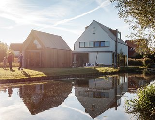 Located on a canal in a neighborhood outside central Amsterdam is the house Mark de Graaf and Sanne Wisman share with their three children. Architects Huib van Zeijl and Daniëlle Segers of Équipe based the pitched-roof house and shed on the local vernacular. "It’s a modern translation of a kid’s drawing of a typical Dutch house," says architect Huib van Zeijl.