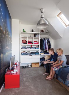In a family's house in Amsterdam, a New York cityscape takes up one wall in Bram’s room, which has furnishings from Ikea and a bed from Goed Gemaakt.