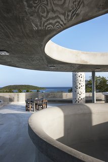 The Acrobatic Wonders of Concrete - Photo 3 of 10 - El Blok, a 22-room hotel in Vieques, Puerto Rico, strikes a unique profile—its meandering shape features numerous cut-outs that let light in, casting playful shadows. The LEED Gold-certified property, designed by San Juan-based firm Fuster + Architects, shows the texture of the plywood boards that were used to create the building's formwork.