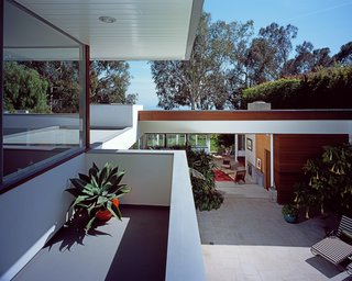 A Neutra Renovation in Los Angeles - Photo 3 of 6 - The original house opens completely to the repaved pool deck, which leads to the upstairs addition. "Working on the house had only increased our respect for Neutra, whom we had always admired greatly," says Grueneisen. "So we knew that any major additions would have to be respectful to his design."