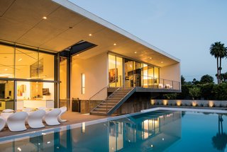 A collection of Miss Petra chairs from Myyour are next to the pool; all lighting for the house is by Skip Yeknik.