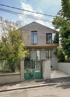A shift in material on the facade, from concrete to red cedar, delineates old and new spaces.