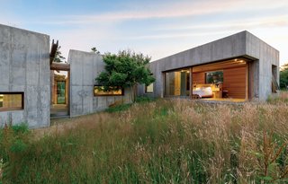 Six modular, concrete boxes comprise a five-bedroom home on Martha’s Vineyard, in Chilmark, Massachusetts. Designed with the sloping seaside site in mind, it was built to guard against potential erosion: Connected by interstitial wood paneling, each of the six units can be moved in just a week and fully installed in a few months.