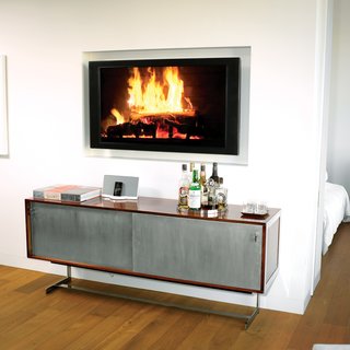 No room for a built-in bar? Wing it, like architect Cass Calder Smith did in his SoHo apartment, with a modern cabinet, trays to hold bottles and glasses, and a roaring "fire."Photo by <br><br>Brian Finke.