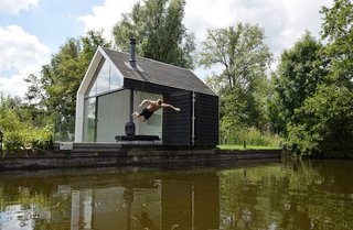 Subtle features incorporated into the design, including an elevated terrace and jetty, help the home float above the island.