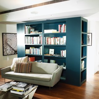 Calder Smith created the custom bookcase to delineate the seating area and the entrance hallway.
