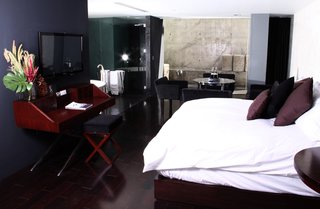 This room managed to feel cozy despite the polished concrete, dark interiors, and glass walls.