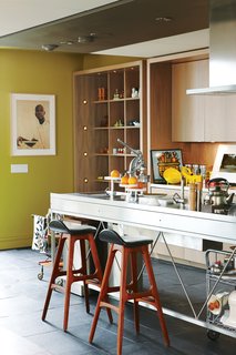 The kitchen takes on a gallery feel. "I’ve got art on the kitchen counter. I really want to say to people, ‘Don’t take art so seriously,’" says Montague.