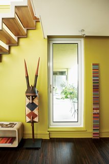 In the library, Douglas Coupland’s Spectra sculpture sits next to a century-old helmet mask from Burkina Faso.