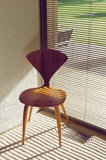 A side chair by Norman Cherner with its back overlooking the golf course.
