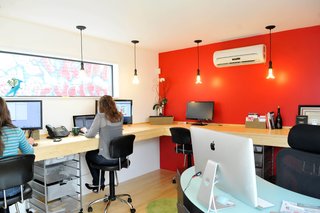 For the realty group interior space, eight people comfortably work in the 12-foot-by-14-foot room. There’s a mini slit A/C and heating system, painted sheetrock walls and bamboo floors and desk.