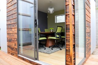 The other unit is a conference room with bamboo floors.