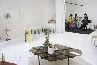 The three women of Egg stand in the background. They come from backgrounds in woodwork, architecture, sculpture, and urban planning. After meeting in college they came together years later to form the business.