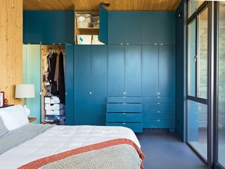 In such a small space "you have to organize, and every piece takes a decision," says resident Heidi Wright. The couple keep things they use less frequently, like guest bedding, in the higher cabinets.