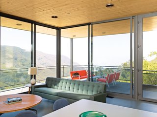 The sofa and lights in the open-plan living, dining, and kitchen area are vintage.