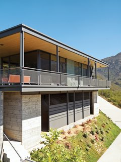 Fir slats on the wall and ceiling run through to the outdoors, visually expanding the space.