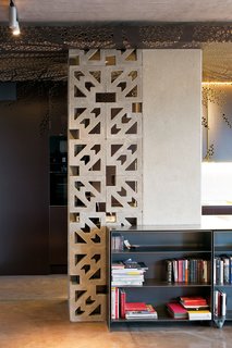 Ornate concrete blocks screen a storage area in the kitchen while letting light through. The effect is "romantic—romantyczny," says Nix.