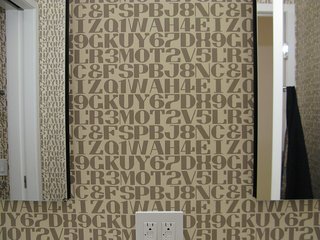 More patterned wallpaper in the bathroom.