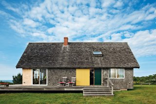 Jens Risom's Block Island Family Retreat - Photo 6 of 13 - Originally, glass doors opened to the deck, but after years of gusty winds, it was decided that a side entrance, protected by a sliding steel door, would be the preferred entrance.