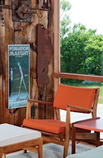 Jens Risom's Block Island Family Retreat - Photo 13 of 13 - An orange chair and cream ottoman of Risom's design.