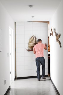 The First LEED Gold-Certified Family Home in San Diego - Photo 10 of 13 - Soheil steps into the music and screening room, which is concealed behind a masonry-veneered door. "We were able to hide a lot of the square footage below the main level, but not in a way that would hurt the design," he says.