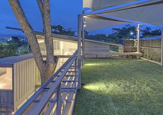Who Knew a Relaxing Tropical Retreat Could Be Made of Shipping Containers? - Photo 1 of 10 - Trejos finished the roof with artificial grass, creating a terrace perfect for dinner parties as well as morning yoga sessions. The client's wife, a ballerina who teaches antigravity yoga, where participants are suspended from textiles, also made the suggestion to include the oversized cloth sails above the roof, a reference to her fitness routine.
