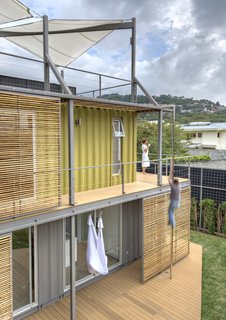 This modern residence and gallery near San Jose, Costa Rica uses metal boxes like puzzle pieces to create a photographer's dream home.