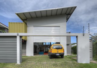 Who Knew a Relaxing Tropical Retreat Could Be Made of Shipping Containers? - Photo 9 of 10 - The slanted roof above the garage, painted white to reflect the heat in the tropical environment, also contains a solar heating system for water. The home also features a rainwater collection system, particularly useful during the long rainy season.