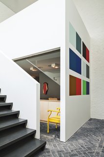 This House Proves Art Galleries Can Be Super-Friendly - Photo 6 of 18 - An installation by Willem Cole hangs in the gallery, which leads to an open stairway to the office and private bedrooms upstairs.