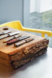 This House Proves Art Galleries Can Be Super-Friendly - Photo 13 of 18 - The kitchen, which the architect tucked into the back of the house, contains wooden cutting boards by Studio Simple and knives by Studio Simple and Antoine Van Loocke.
