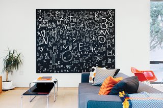 A Home with Eclectic Style Looks Just Right - Photo 1 of 19 - Architect George Bradley and his husband, Eddie Baba, renovated a 1941 house in San Francisco. A painting by Richard Wright and a sofa by Paolo Piva for B&B Italia dominate the family room.
