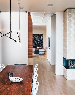 A Home with Eclectic Style Looks Just Right - Photo 6 of 19 - The catwalk above leads to the master bedroom. The living-dining room’s Stix chandelier is from Nido Living.